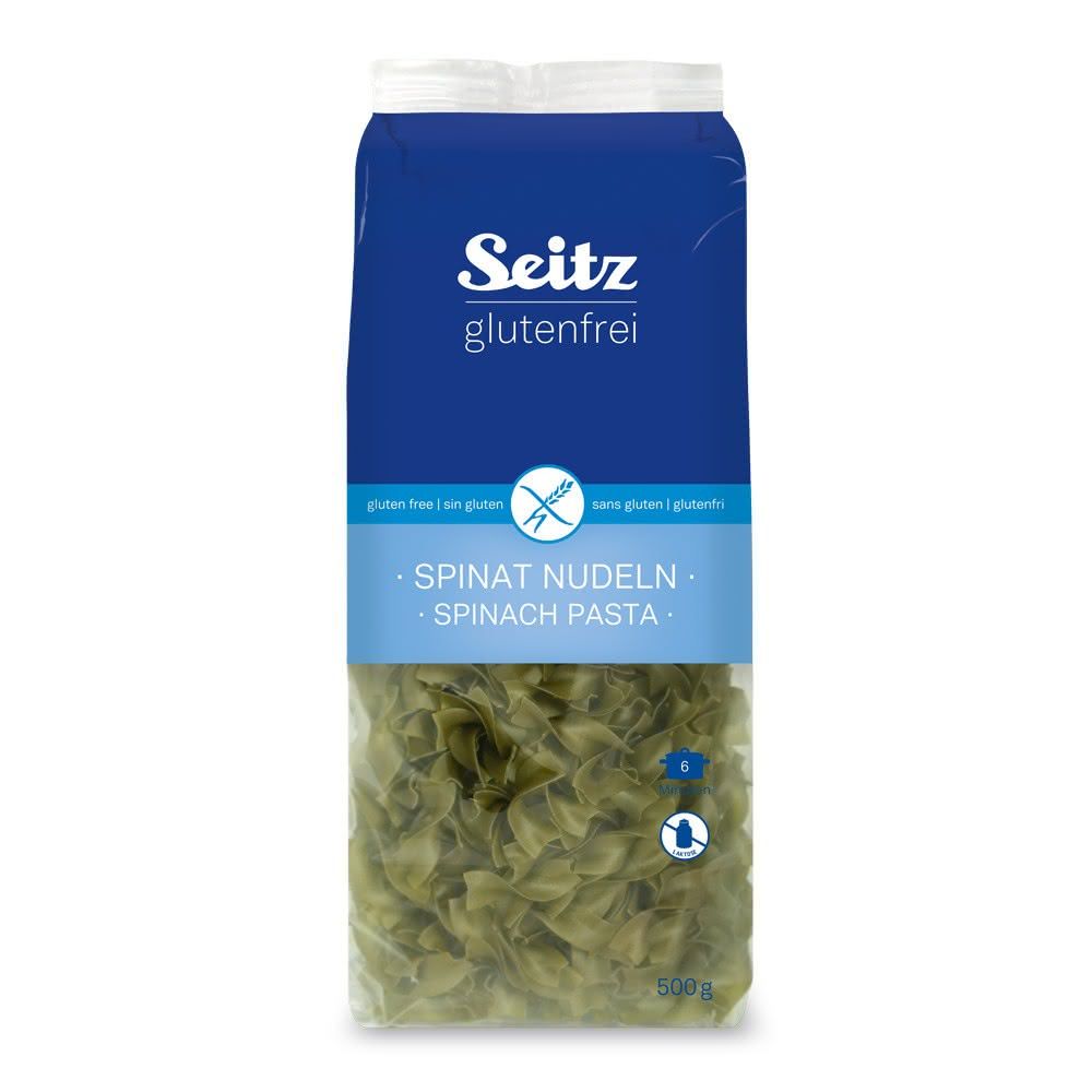 Verpackung mit glutenfreien Seitz Spinat Nudeln. Blaue Verpackung mit Produktnamen und Glutenfrei-Symbol. Sichtbare grüne Nudeln.