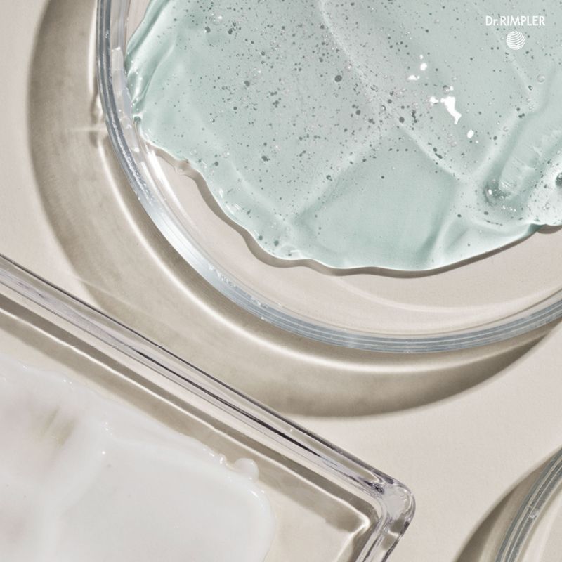 Hellblaues Gel und weiße Creme in Glasbehältern.