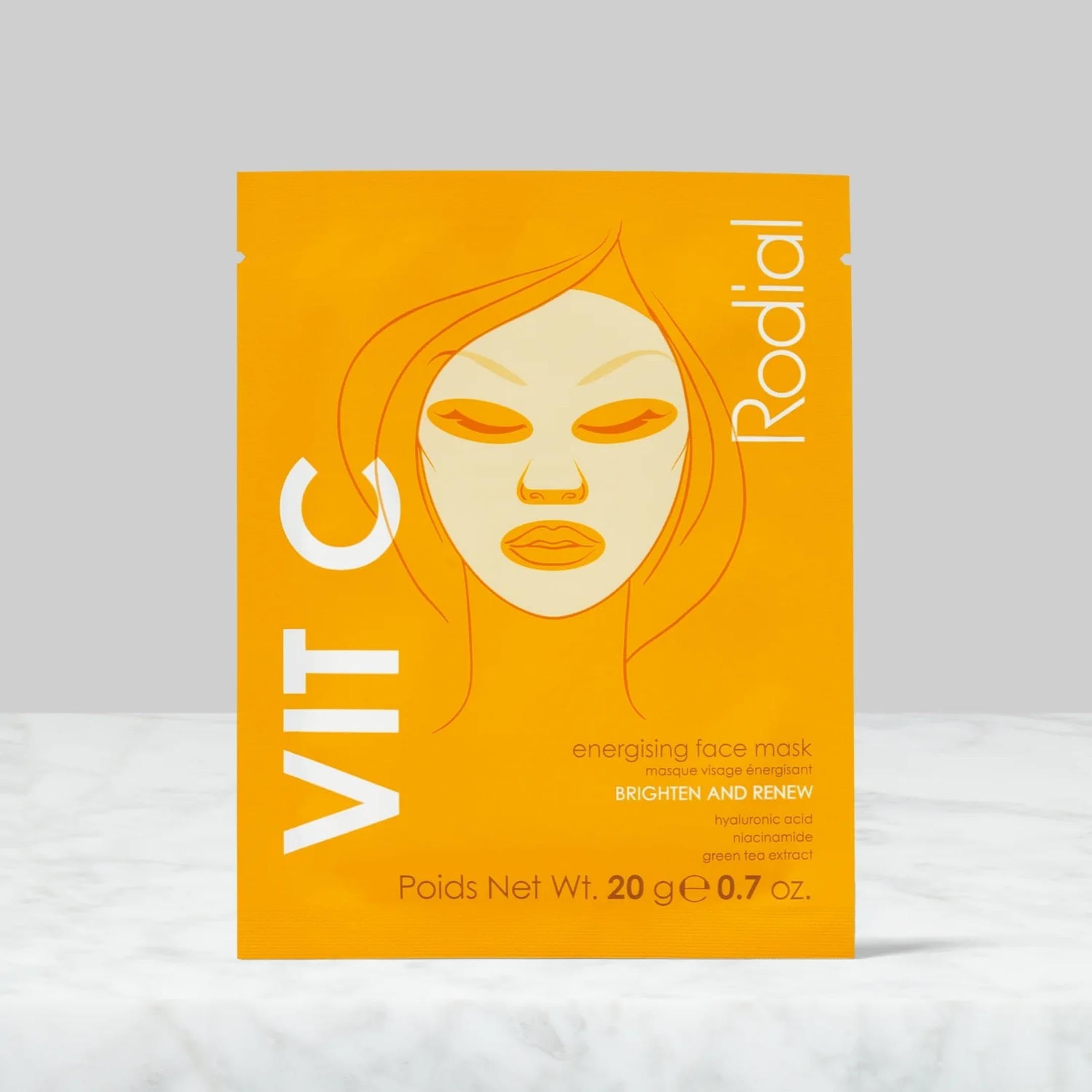 Orangefarbene Verpackung mit Gesichtsskizze und Schriftzug Vit C. Marke Rodial. Text: Energising Face Mask, Brighten and Renew.