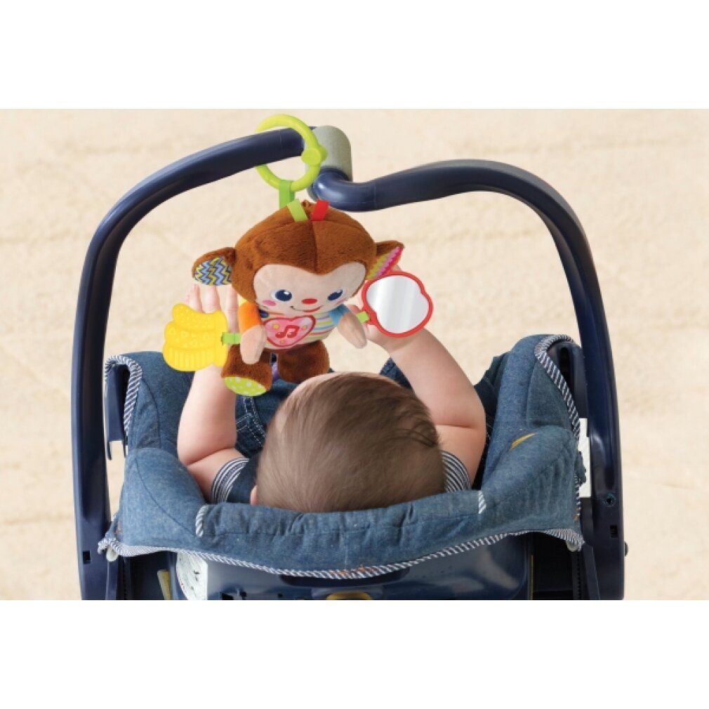 Baby liegt in einem Autositz und spielt mit einem Plüsch-Äffchen. Äffchen mit Spiegel und Beißring.