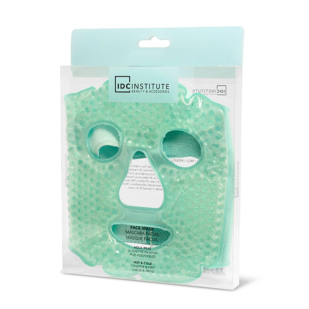 Gesichtsmaske in Verpackung. Grün, wiederverwendbar, mit Kügelchen. IDC INSTITUTE Logo sichtbar.