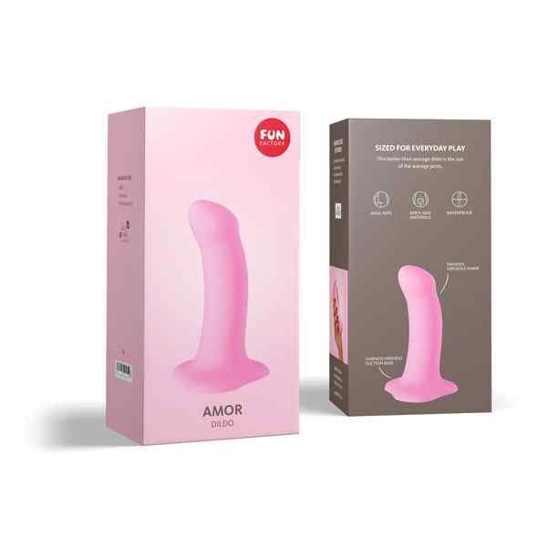 Zwei rosa Verpackungen. Auf einer steht 'Fun Factory Amor Dildo'. Auf der anderen sind Icons und Text.