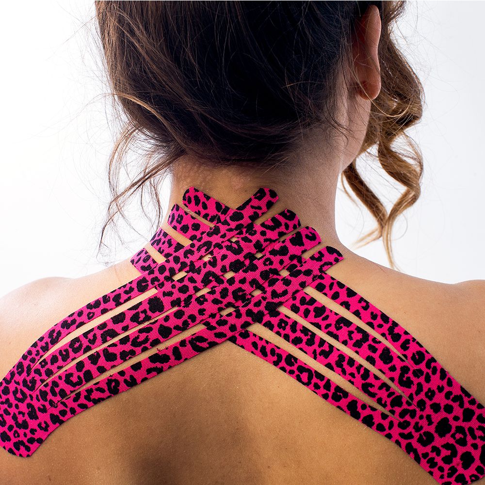 Rosa Kinesiotape mit Leopardenmuster auf dem Rücken einer Person angebracht. Mehrere Streifen kreuzen sich.