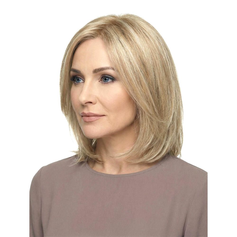 Blonde Perücke mit gestuften Haaren. Seitenansicht einer Frau mit der Perücke. Hellbraunes Oberteil.