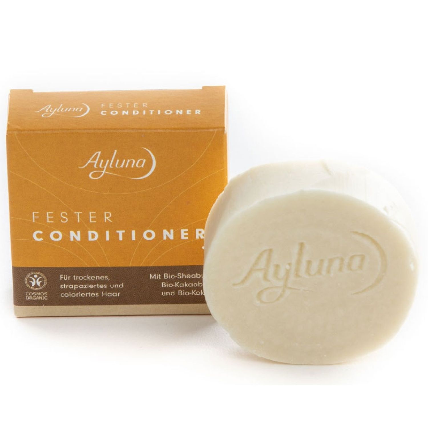 Conditioner-Stück und Verpackung. Aufschrift: Ayluna, Fester Conditioner. Für trockenes, strapaziertes Haar.