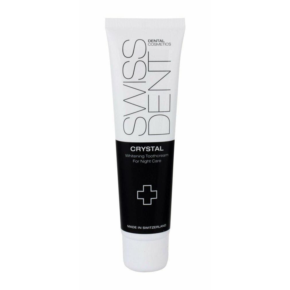 Zahncreme-Tube, weiß und schwarz. Aufschrift: SWISSDENT, CRYSTAL, Whitening Toothcream For Night Care. Kreuz-Symbol. Hergestellt in der Schweiz.