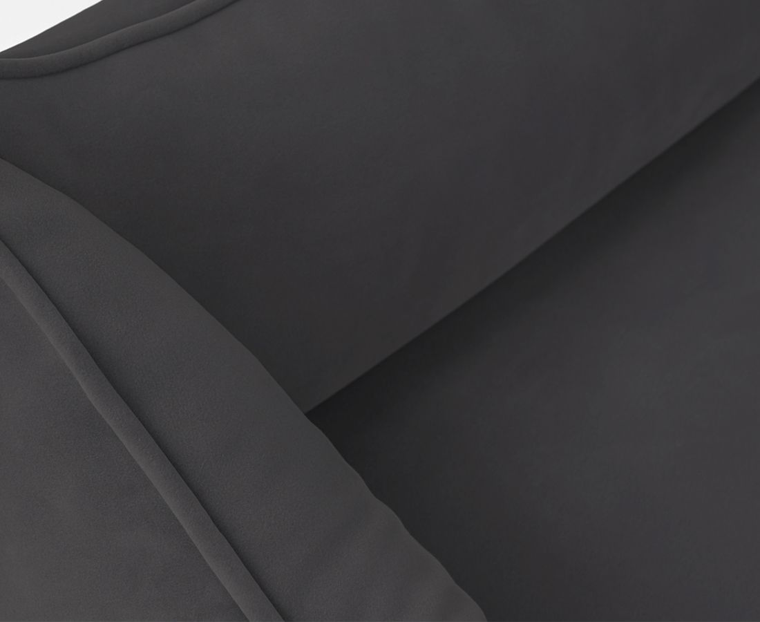 Detailansicht des orthopädischen Hundebetts Jona. Dunkelgraues Material. Erhöhte Seiten. Nahtdetails. Auf weißem Hintergrund.