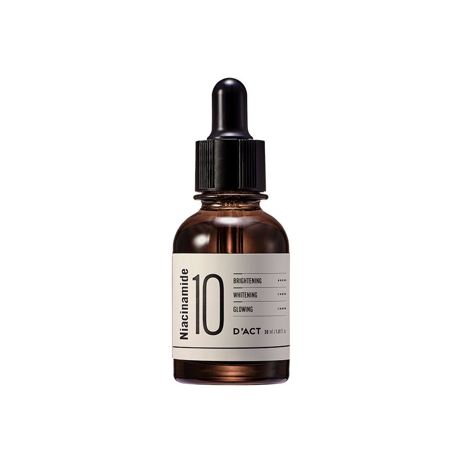Braune Glasflasche mit schwarzem Deckel und Pipette. Etikett mit "Niacinamide 10" und "D'ACT".