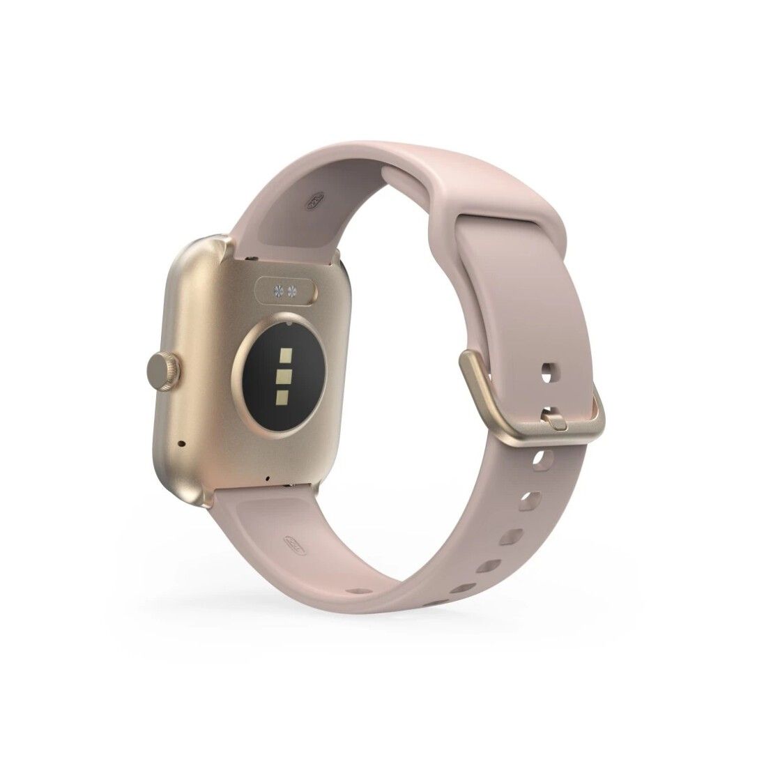 Rückseite einer roséfarbenen Smartwatch mit goldfarbenem Gehäuse. Sichtbar sind Sensoren und Ladekontakte.