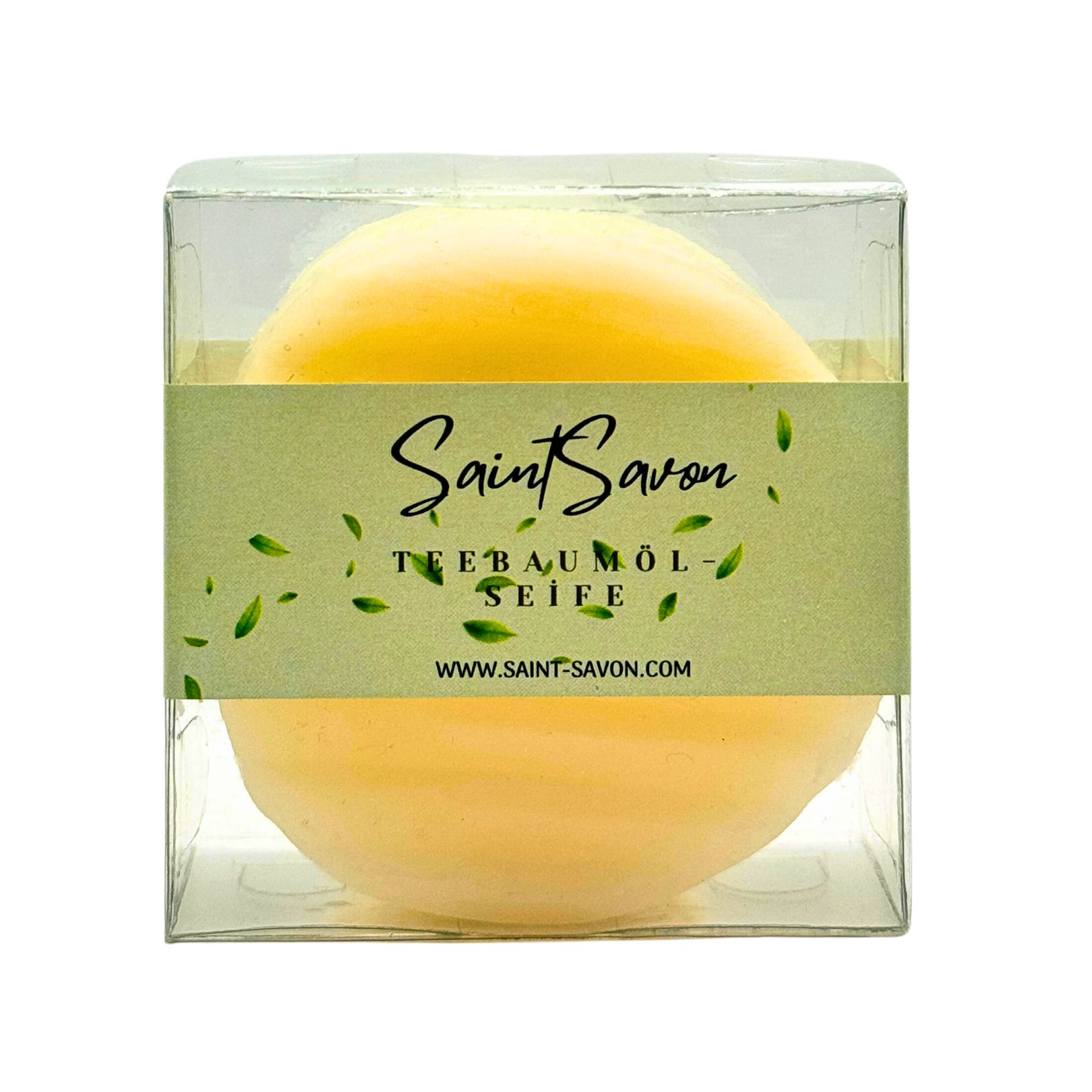 Gelbe Seife in transparenter Verpackung. Aufschrift: Saint Savon Teebaumöl Seife. Grüne Banderole mit Blättern.