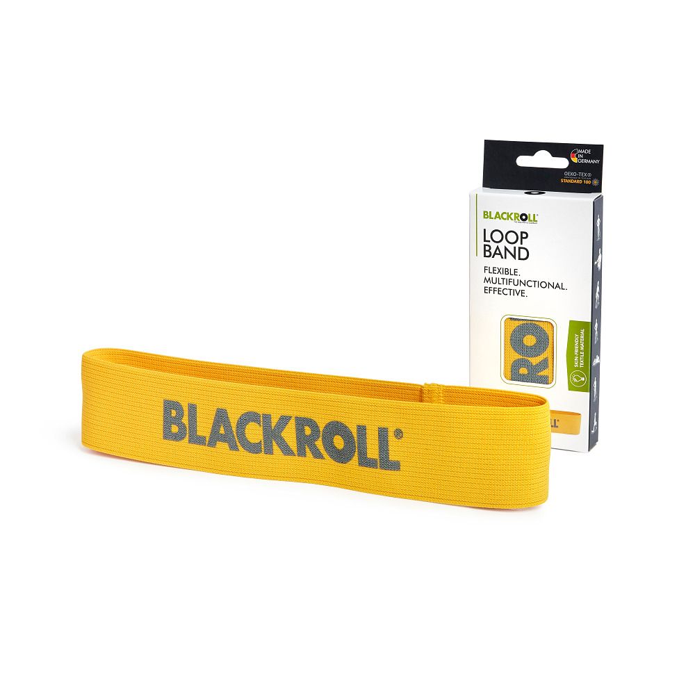 Gelbes BLACKROLL Loop Band neben einer Verpackung. Auf der Verpackung steht 'LOOP BAND'.