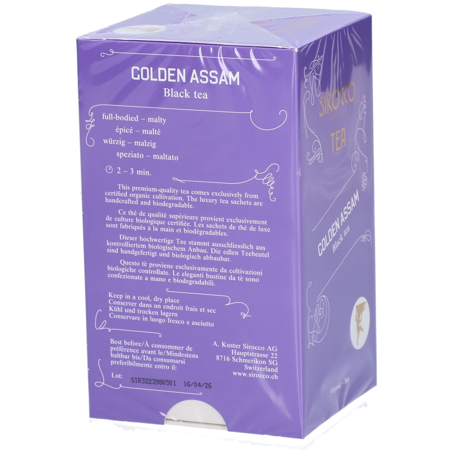 Violette Verpackung mit "Sirocco Tea Golden Assam". Rückseite mit Text, Haltbarkeit, und Hersteller.