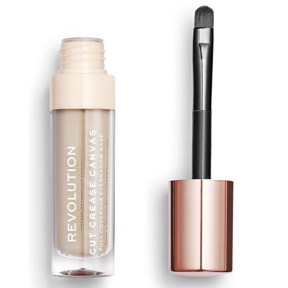Makeup Revolution Cut Crease Canvas Lidschatten-Grundierung. Eine transparente Flasche mit beiger Grundierung und einem Pinsel. Der Pinsel hat einen schwarzen Stiel und eine roségoldfarbene Hülse. Auf der Flasche steht "REVOLUTION CUT CREASE CANVAS".