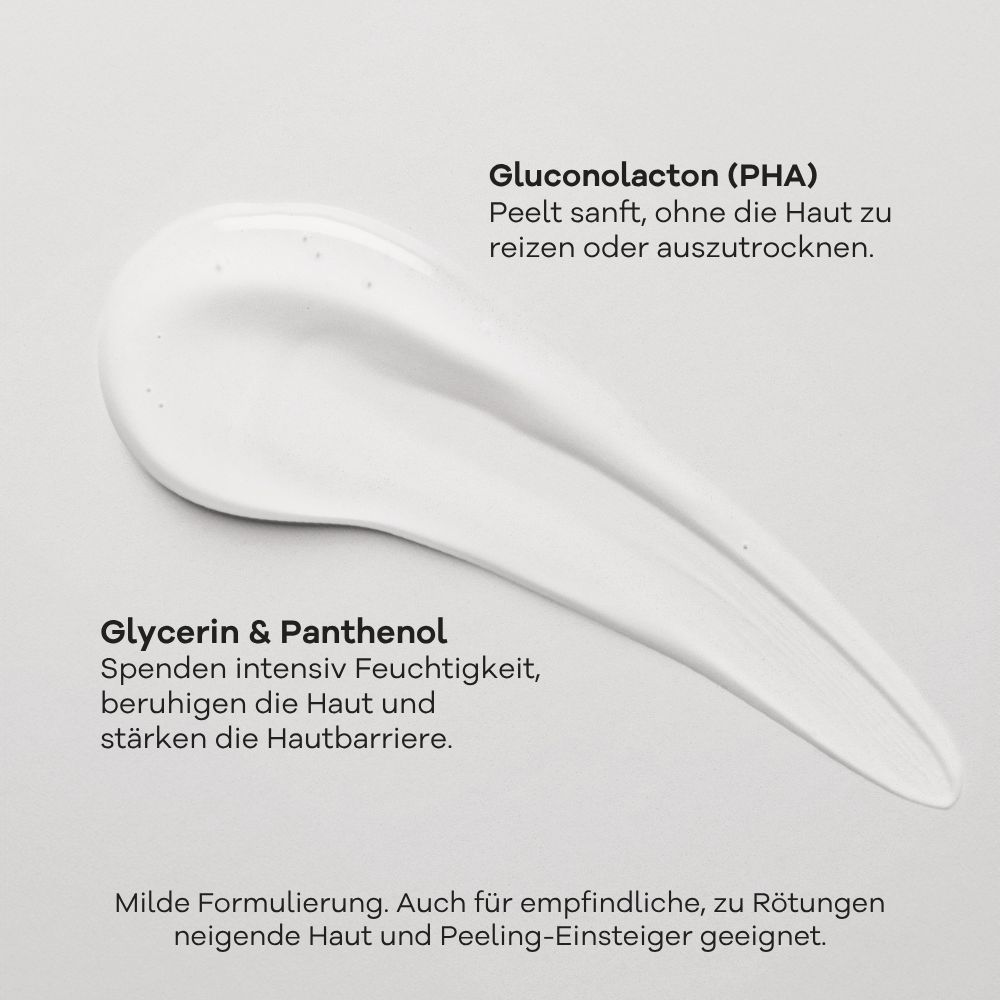 Weiße Serum-Textur mit Glitzerpartikeln auf grauem Hintergrund. Beschriftung: Gluconolacton (PHA), Glycerin & Panthenol.
