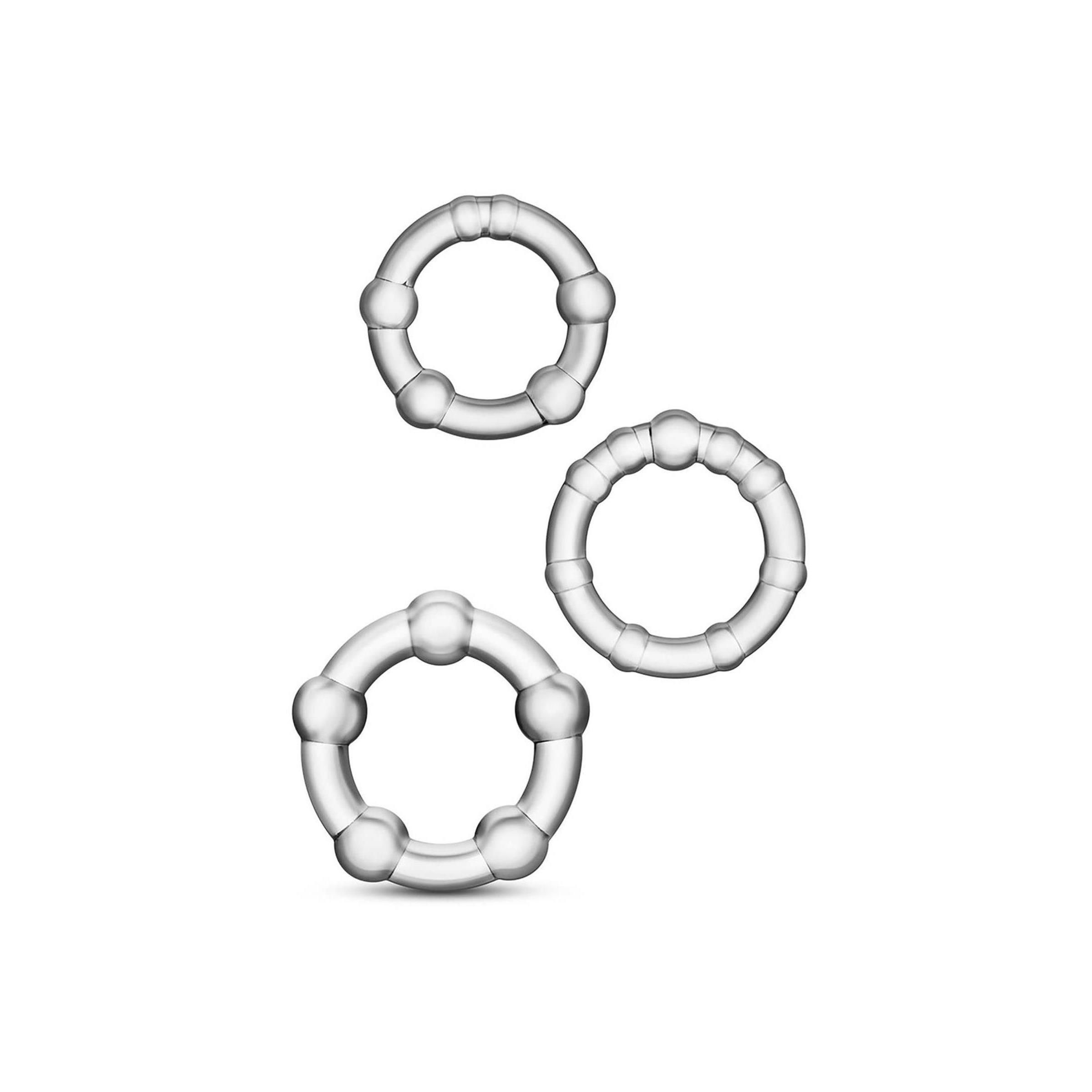 Drei durchsichtige, perlenbesetzte Cockringe. Die Ringe sind rund und haben eine Reihe von Kugeln.