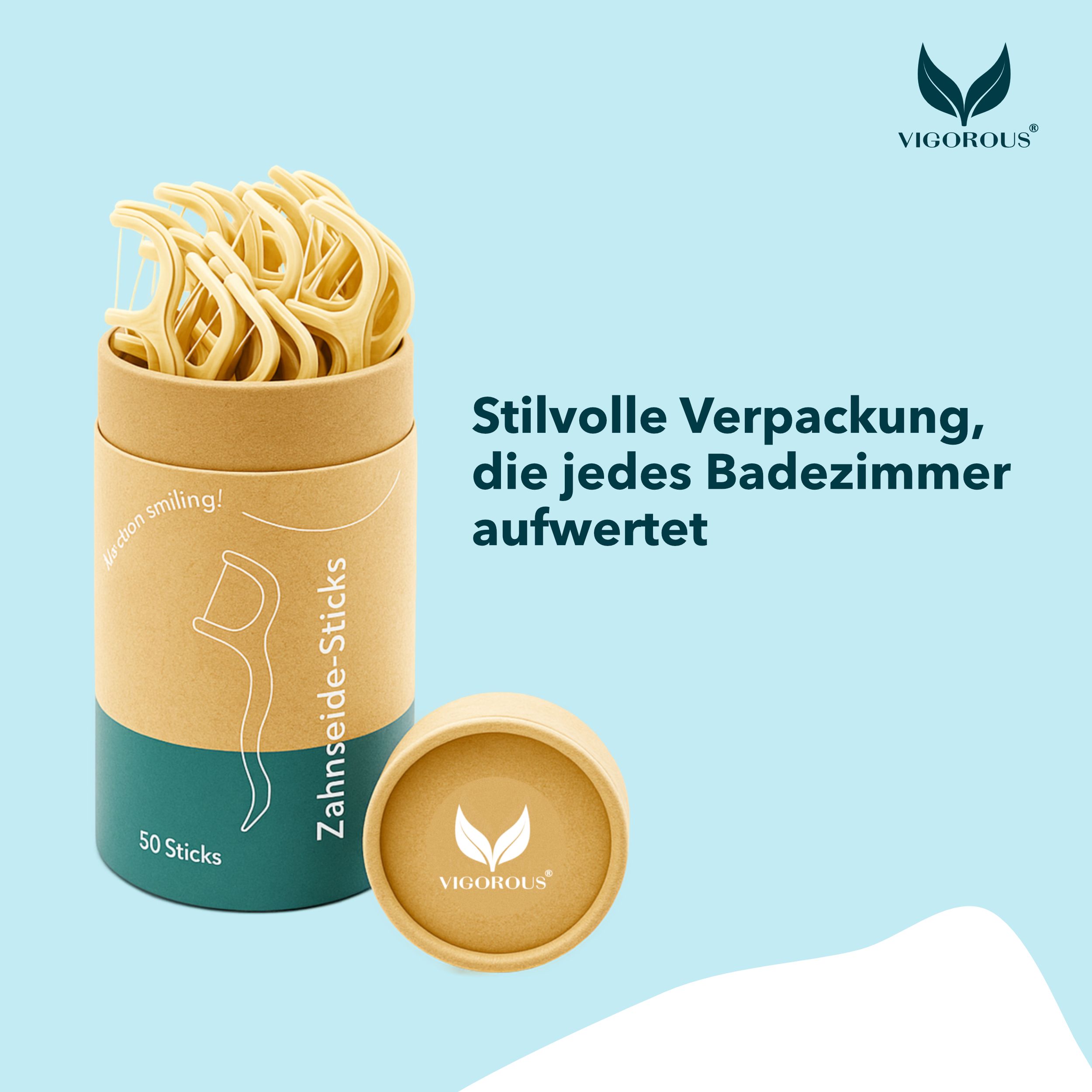 Zahnseide-Sticks in einer zylindrischen Verpackung. Aufschrift: Zahnseide-Sticks, 50 Sticks. Marke: VIGOROUS®. Deckel mit Logo.