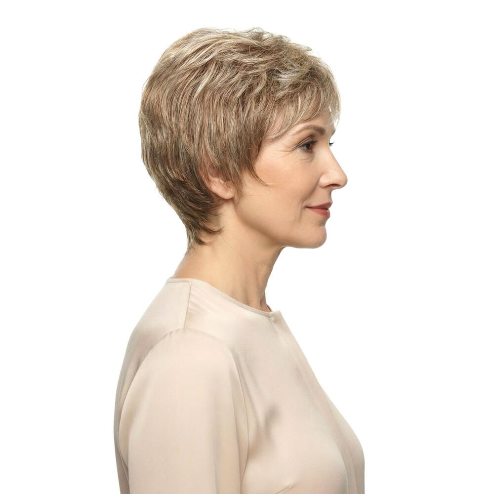 Kurzhaarperücke in Blondtönen. Seitenansicht einer Frau mit Perücke. Helles Oberteil, weißer Hintergrund.