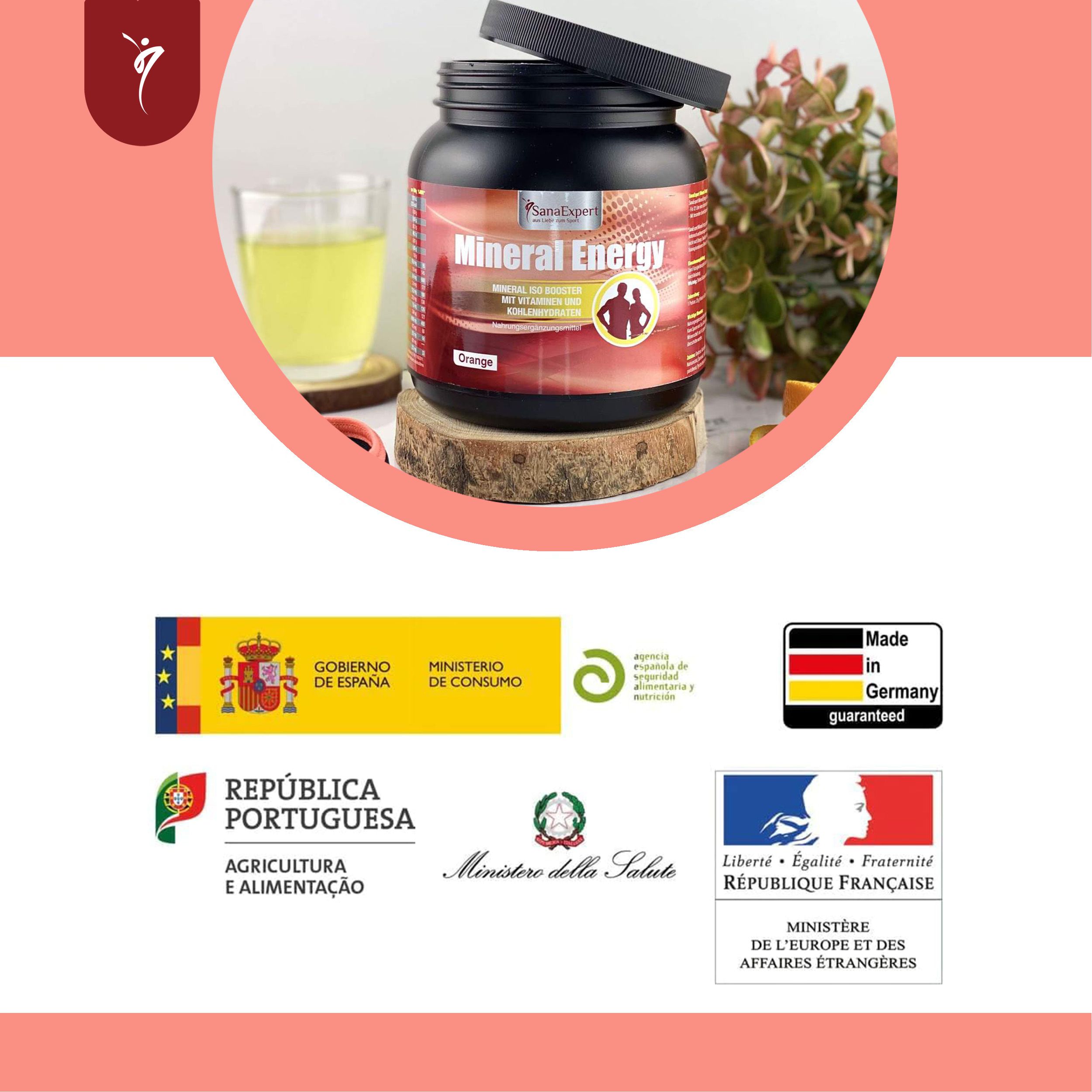 SanaExpert Mineral Energy-Behälter. Schwarzer Behälter mit orangefarbenem Etikett. Auf Holzblock platziert. Glas mit Getränk.
