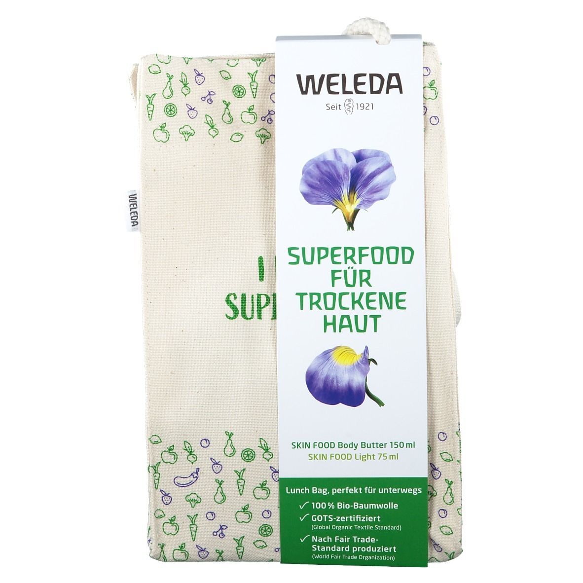 Beige Stofftasche mit Aufdrucken und Anhänger. Aufschrift: SUPERFOOD FÜR TROCKENE HAUT. Marke: WELEDA.