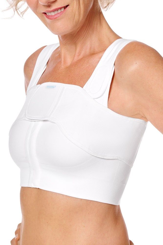 Weißer, anatomischer BH mit breiten Trägern und Reißverschluss vorne. Das Produkt hat einen Klettverschluss und das Logo.