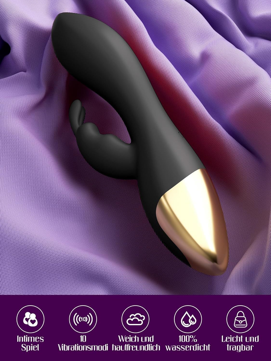 Schwarzer G-Punkt-Vibrator mit goldenem Ende, auf lila Stoff liegend.