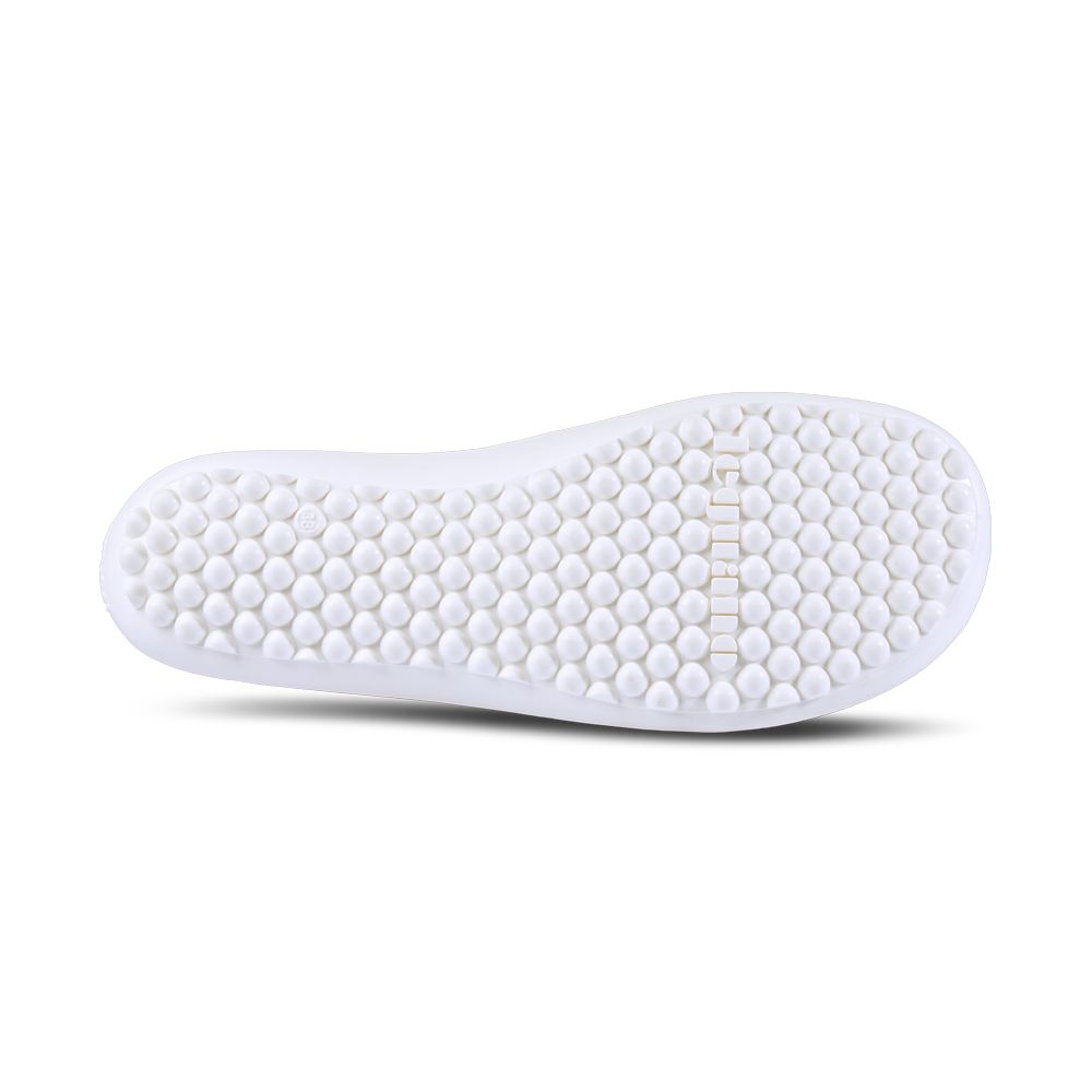 Weiße Schuhsohle mit Noppen. Leguano-Logo mittig. Runde Noppen auf der gesamten Oberfläche.