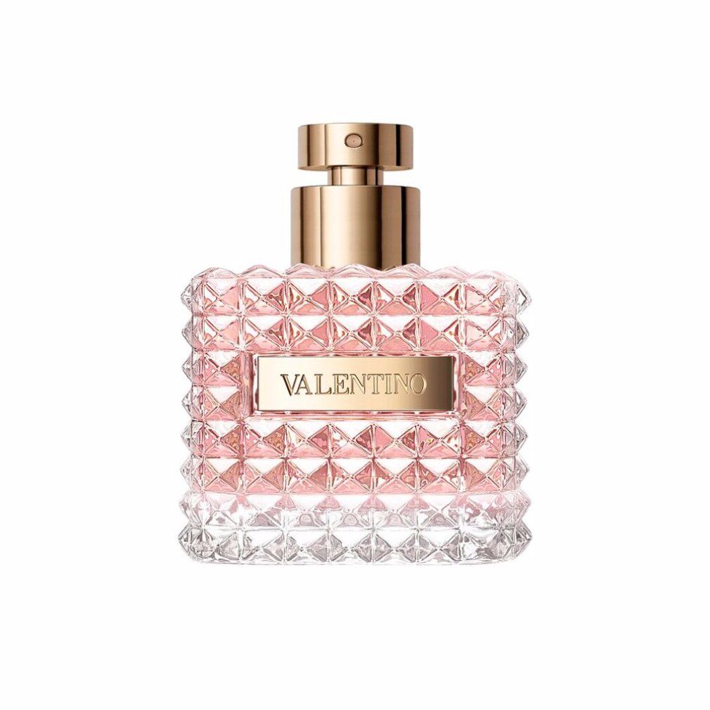 Quadratischer Flakon mit goldfarbenem Verschluss. Aufschrift VALENTINO. Rosa Flüssigkeit sichtbar. Geometrisches Muster auf dem Glas.