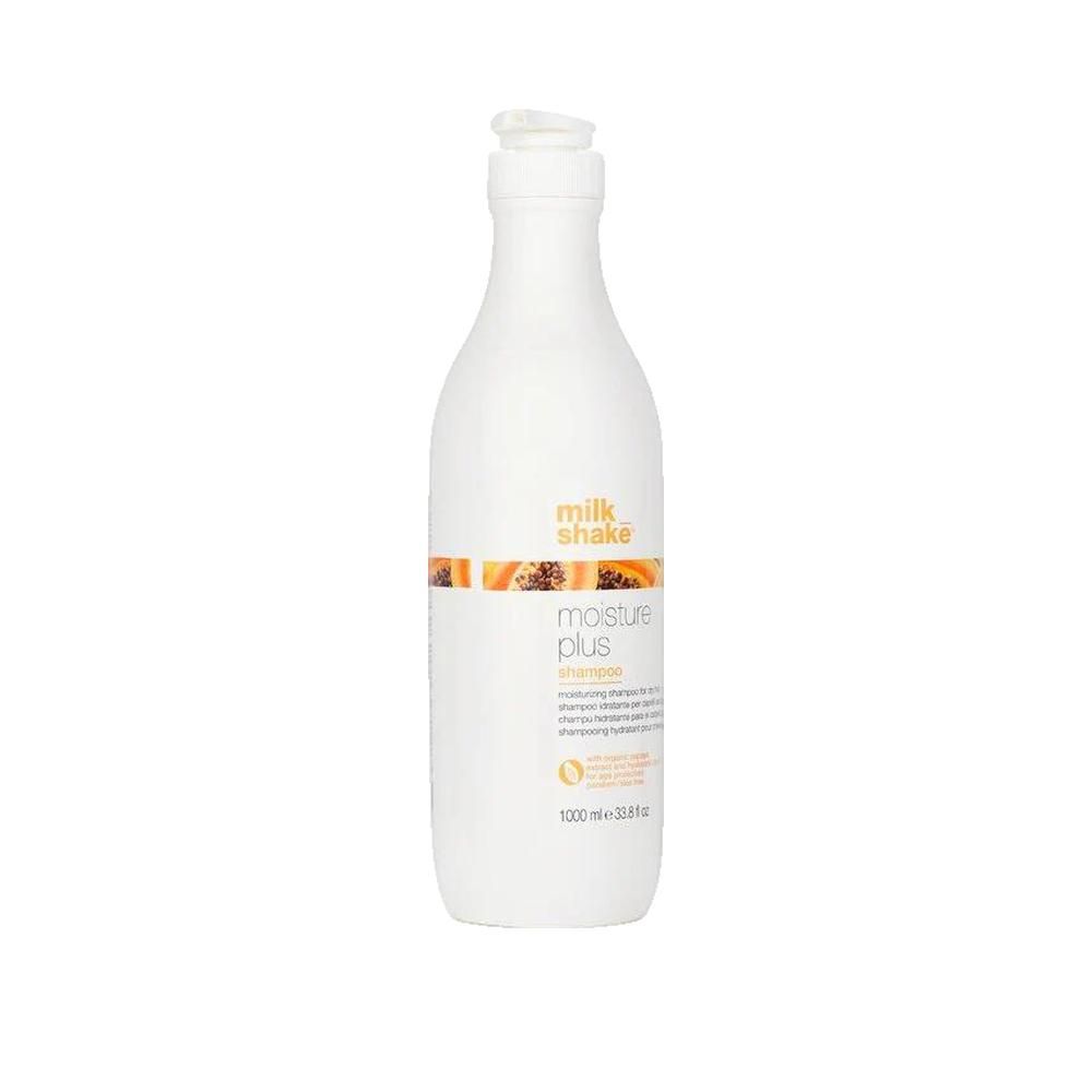 Weiße Flasche mit Pumpe. Aufschrift: milk_shake, moisture plus shampoo. Orangefarbener Streifen mit Papaya-Abbildung. 1000 ml.