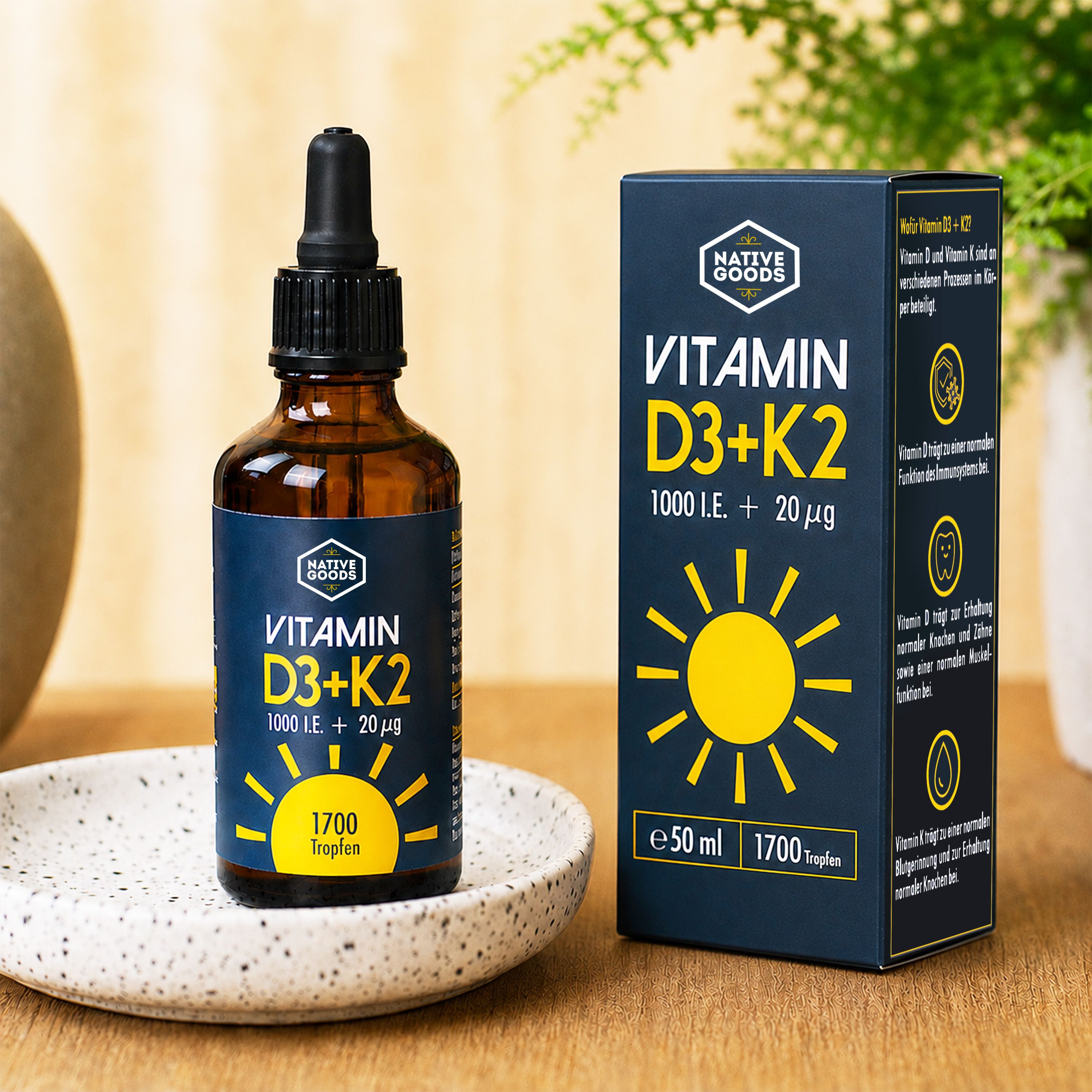 Flasche und Karton von Native Goods Vitamin D3+K2 Tropfen auf einem Tisch.