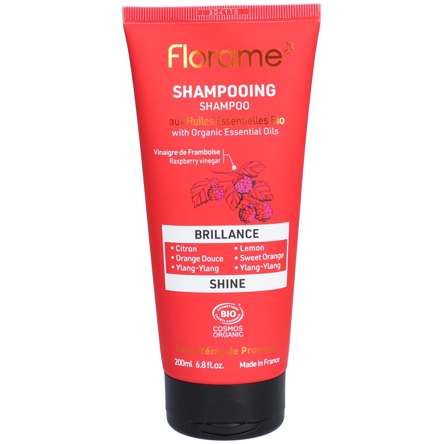 Rote Tube Florame Shampoo. Text: "Shampooing", "Brillance", "Huiles Essentielles Bio".