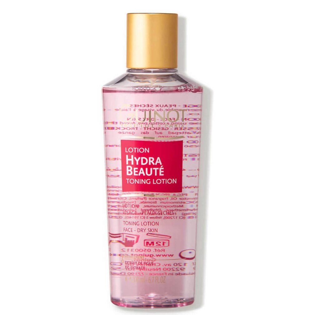 Guinot Hydra Beaute Lotion. Transparente Flasche mit rosa Flüssigkeit, goldfarbenem Deckel. Rotes Etikett mit Produktnamen.