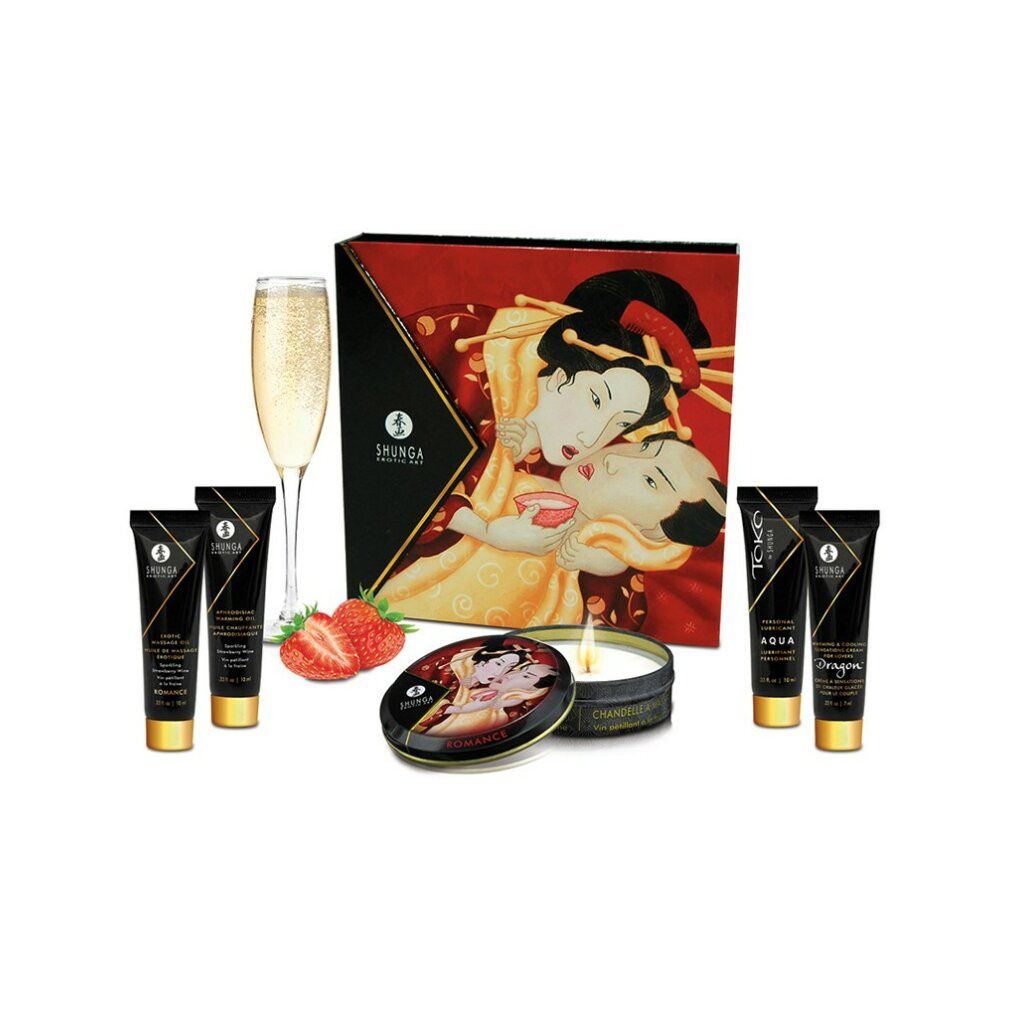 Geschenkset mit Cremes, Kerze, Dose, Erdbeeren und Sektglas. Geisha-Illustration auf der Verpackung. Schwarze Tuben.