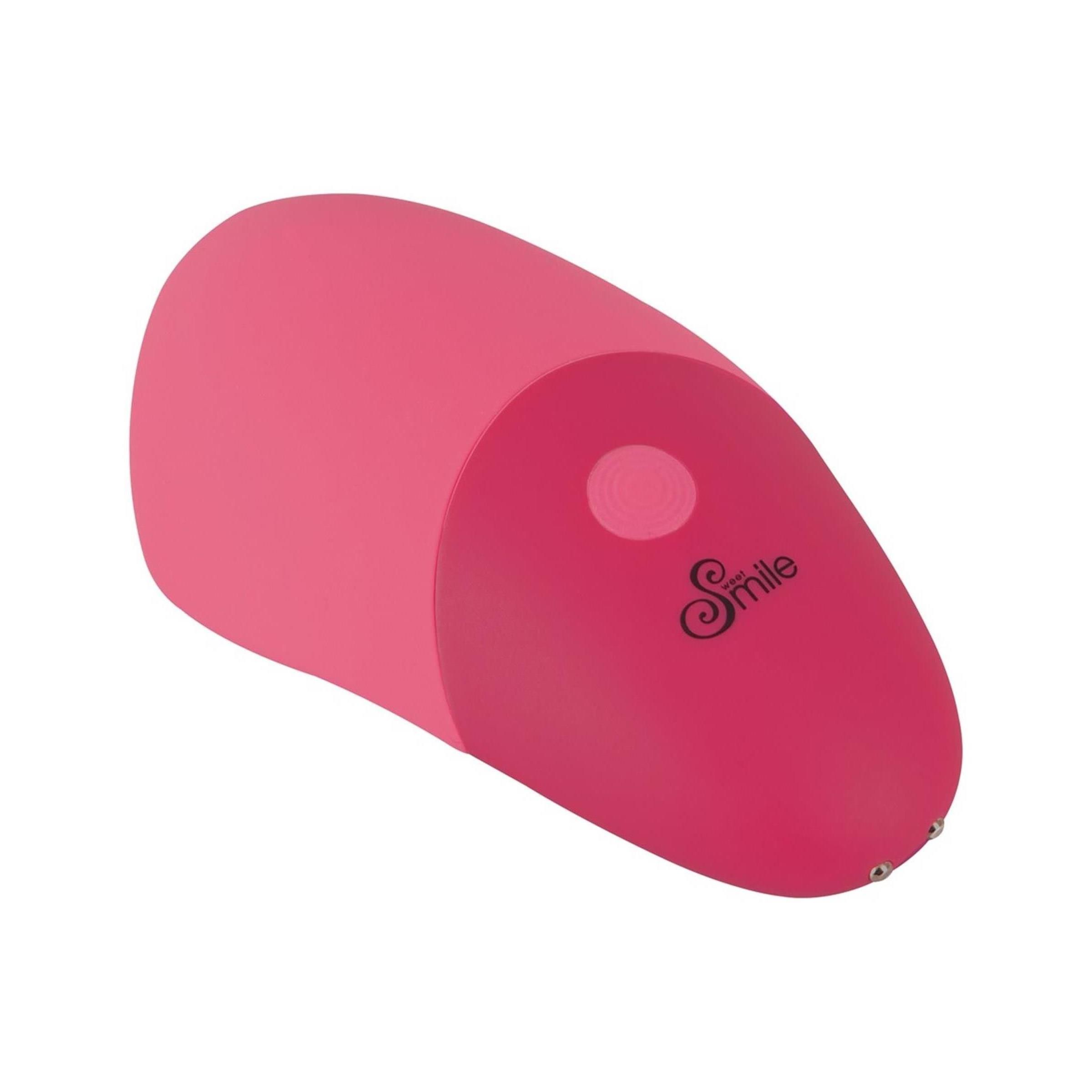 Rosa Vibrator, abgerundete Form. Zwei farbliche Bereiche. Oberteil mit erhabenen Elementen.