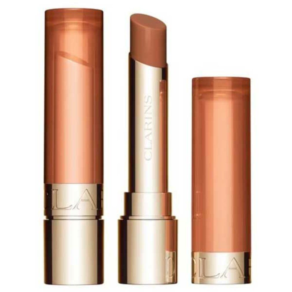 Lippenbalsam mit geöffneter Hülse. Goldfarbene Hülse mit braunem Balsam. Daneben die Hülse.