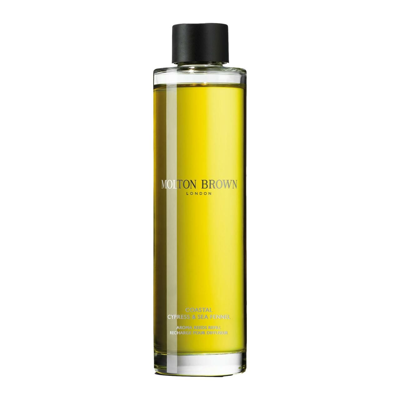 Klare Glasflasche mit gelber Flüssigkeit. Schwarzer Deckel. Molton Brown-Logo und Produktbezeichnung auf dem Etikett.
