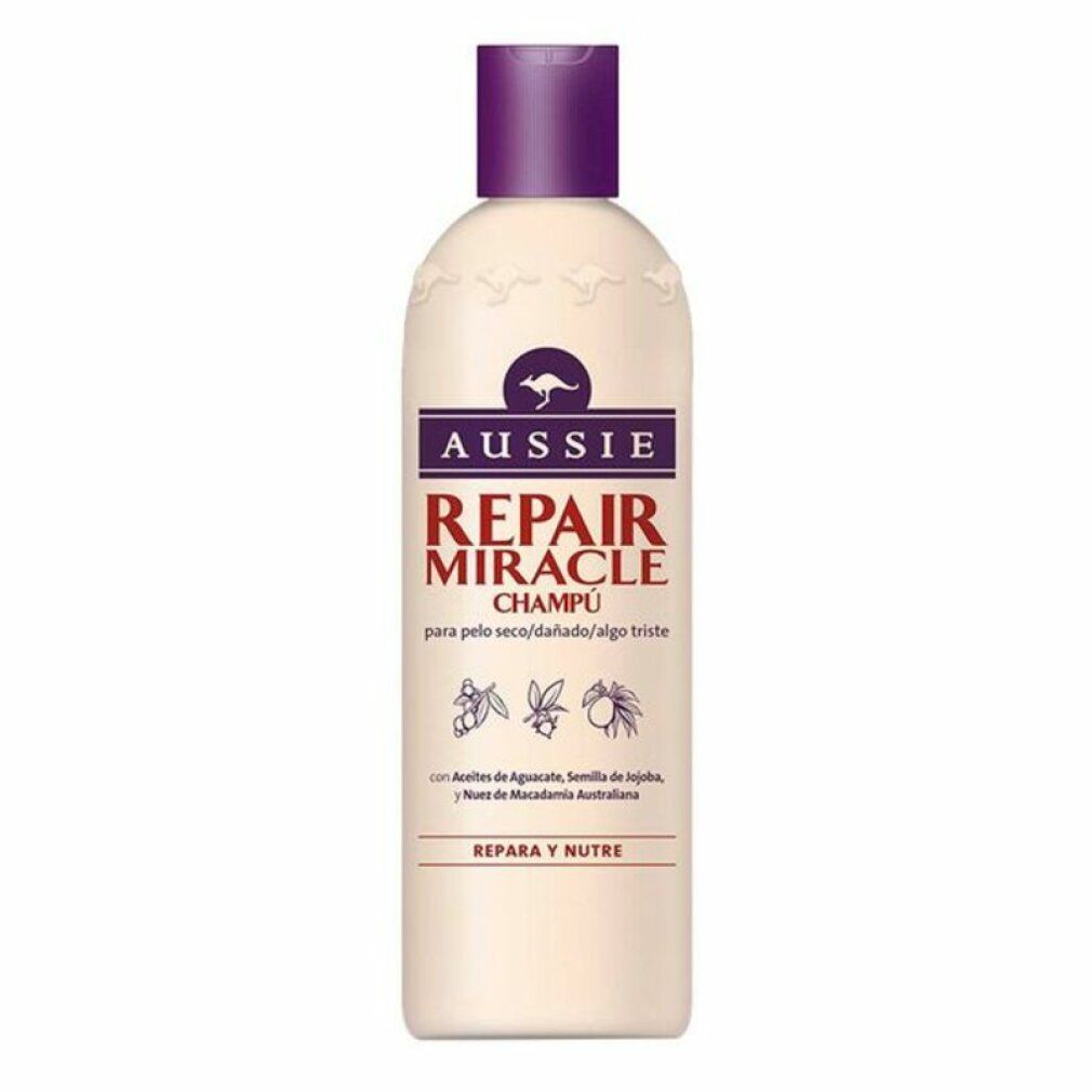 Beige Shampoo-Flasche mit lila Deckel. Aufschrift: Aussie Repair Miracle Champú. Enthält Avocado, Jojoba und Macadamia.
