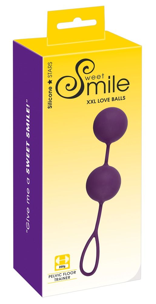 Verpackung mit zwei violetten Kugeln, verbunden durch einen Steg, mit Schlaufe. Text: Sweet Smile, XXL Love Balls.