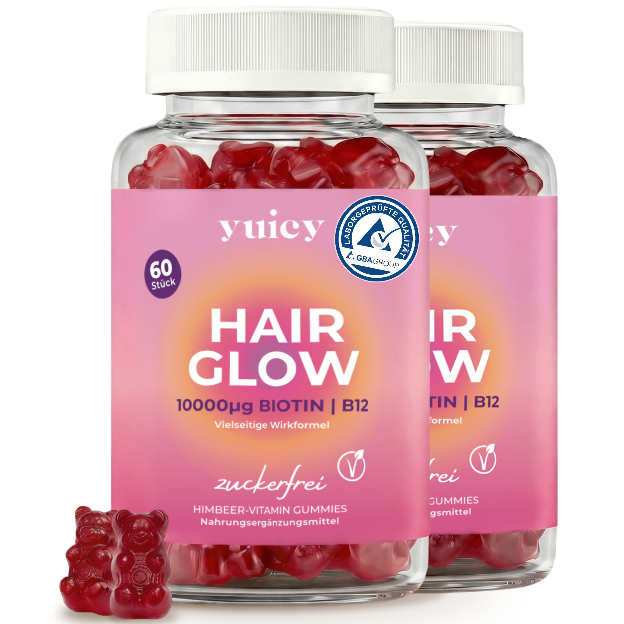 Zwei Flaschen yuicy Hair Glow Biotin, 60 Stück, Himbeer-Vitamin-Gummies, zuckerfrei. Drei Gummibärchen daneben.