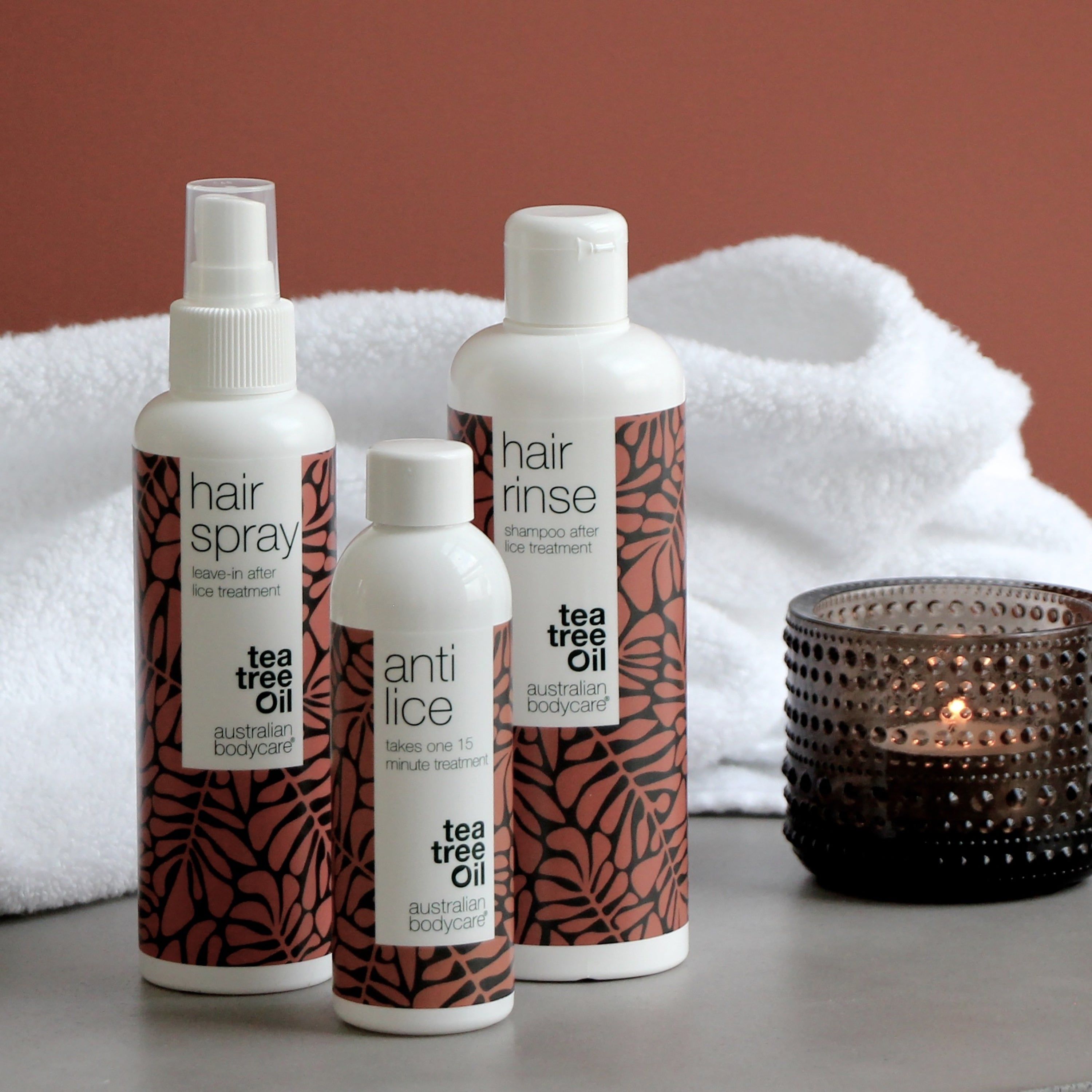 Drei Produkte: Hair Spray, Hair Rinse und Anti Lice. Alle in weißen Flaschen mit braunen Blättern. Tea Tree Oil.