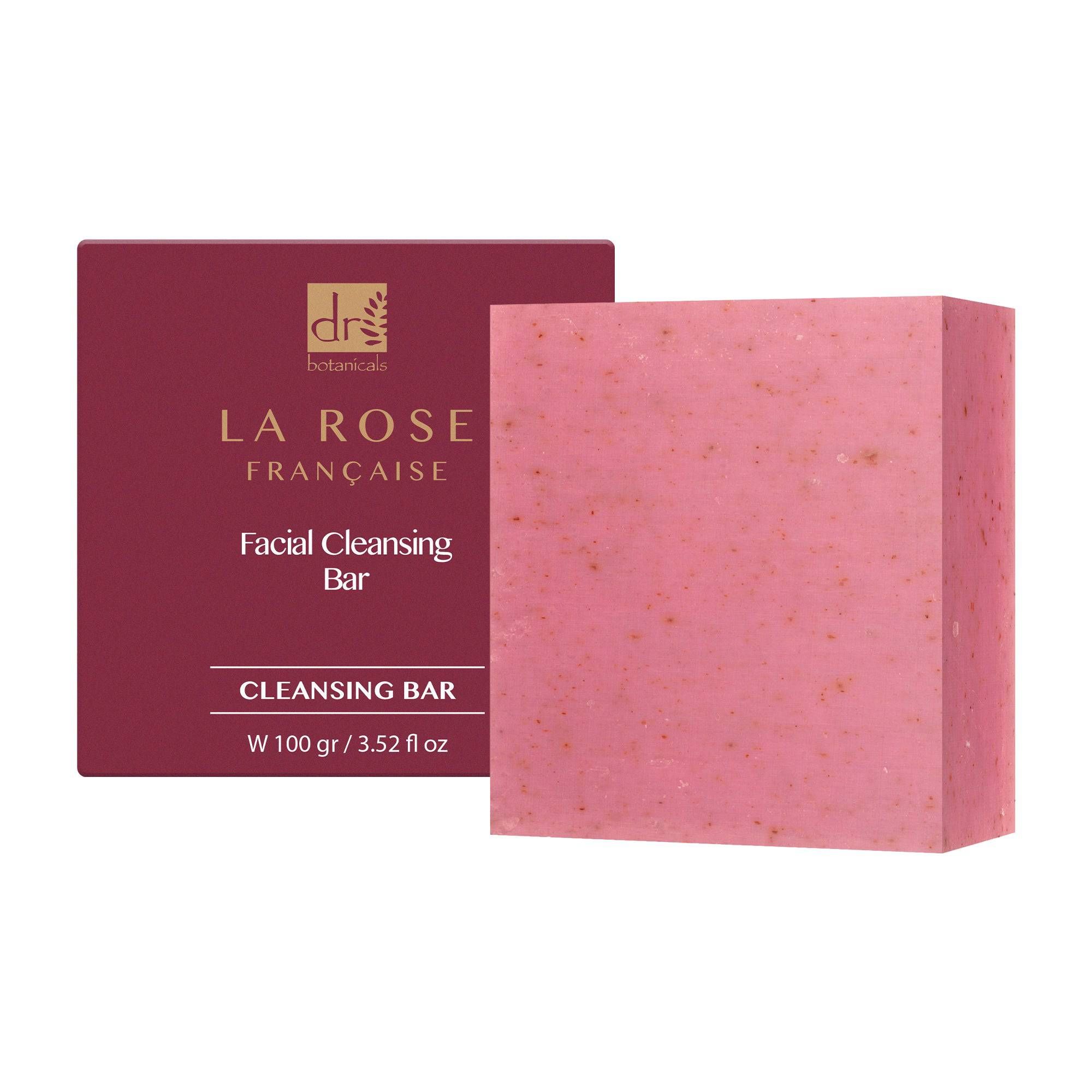 Rosa Blockseife neben Verpackung. Verpackung mit Logo und Text. "Facial Cleansing Bar".