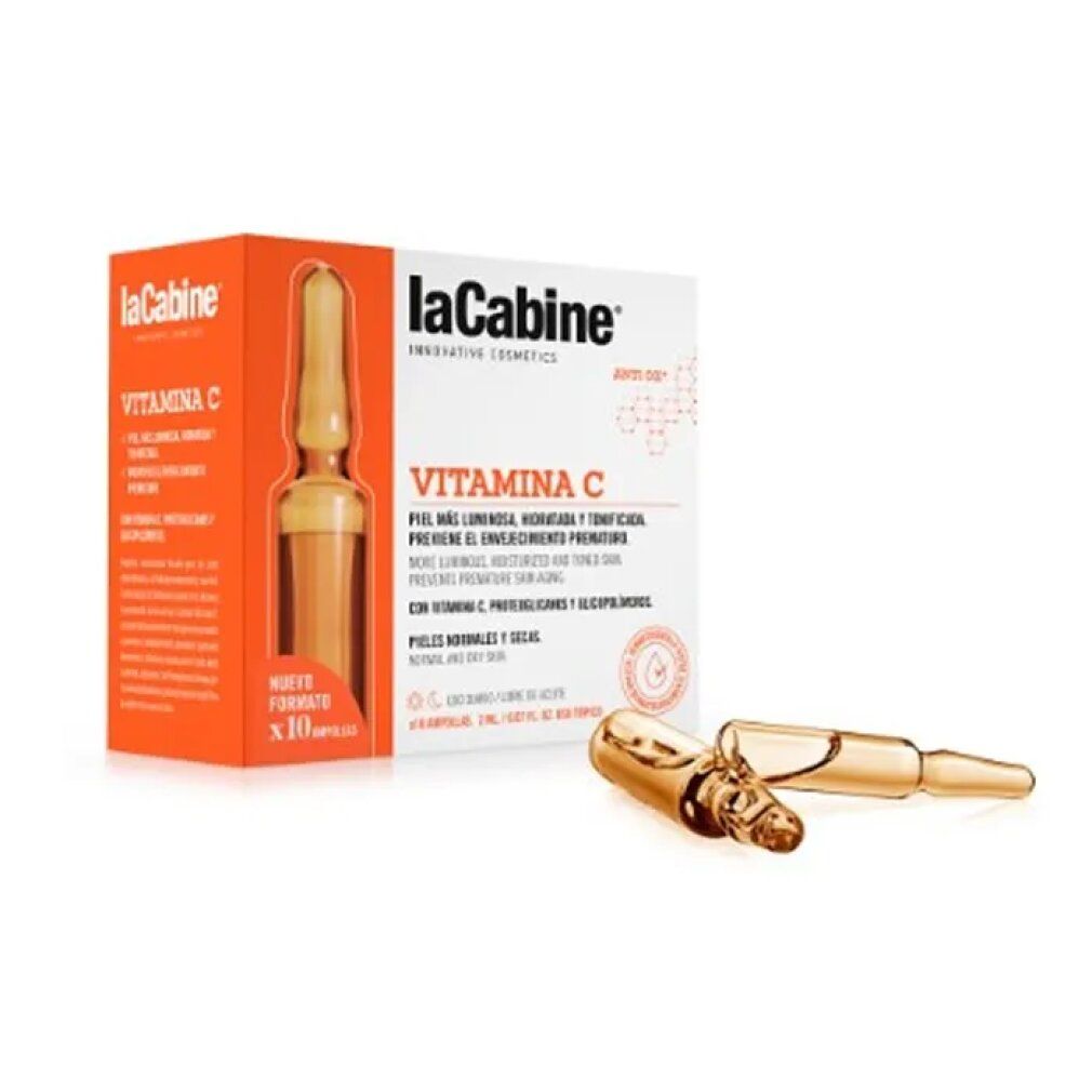 La Cabine Vitamin C Ampullen-Packung und zwei Ampullen. Die Packung ist orange und weiß, mit Produktinformationen. Ampullen bernsteinfarben.