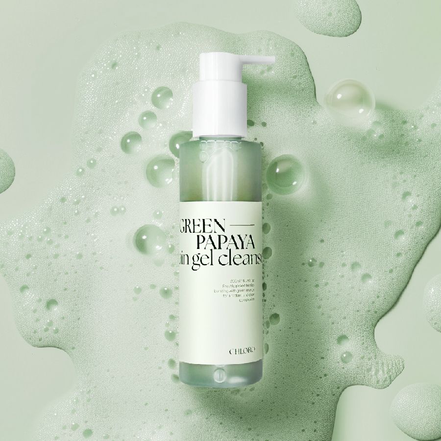 Grüne Flüssigkeit in einer Flasche mit Pumpe, umgeben von Schaumblasen. Aufschrift: GREEN PAPAYA in gel cleans.