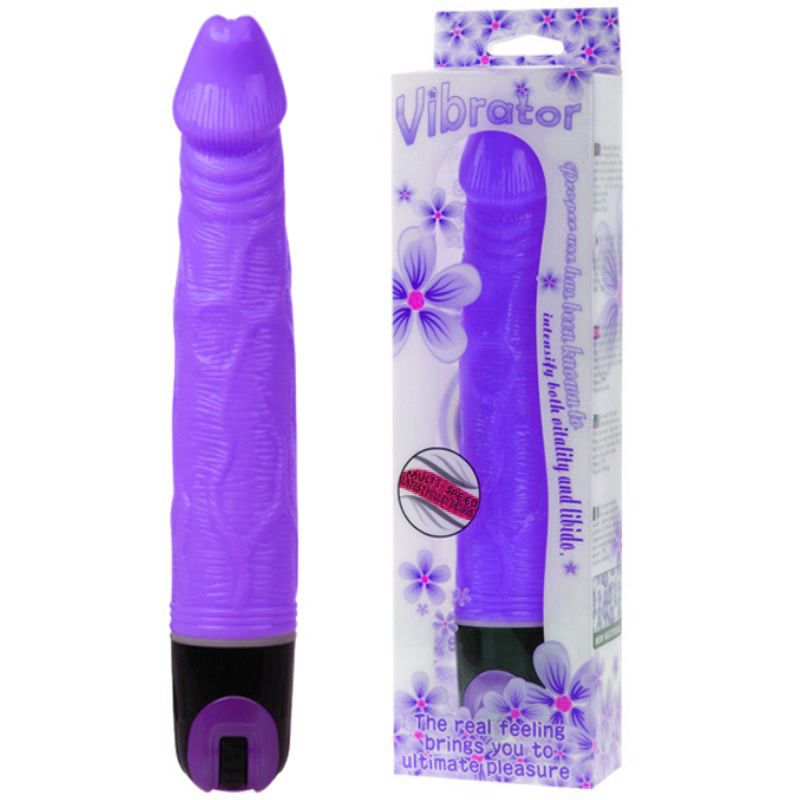 Lila Vibrator neben Verpackung. Aufschrift "Vibrator". Blütenmuster. Text: "The real feeling brings you to ultimate pleasure".