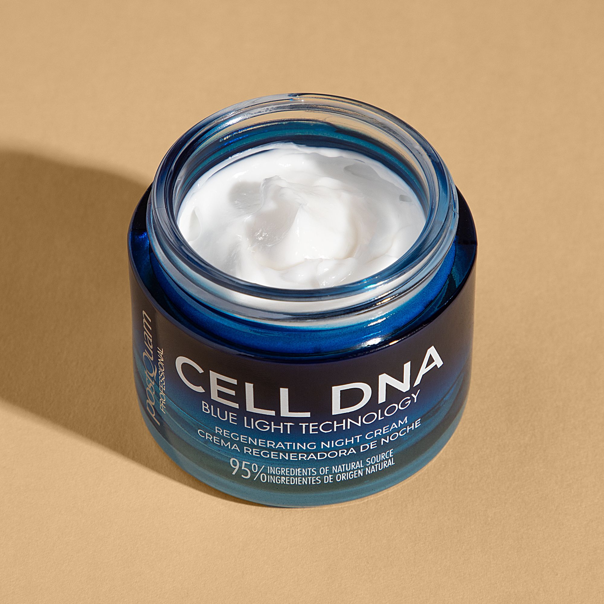 Geöffneter Creme-Tiegel mit weißer Creme. Aufschrift CELL DNA, Blue Light Technology, Regenerating Night Cream. 95% Inhaltsstoffe natürlichen Ursprungs.