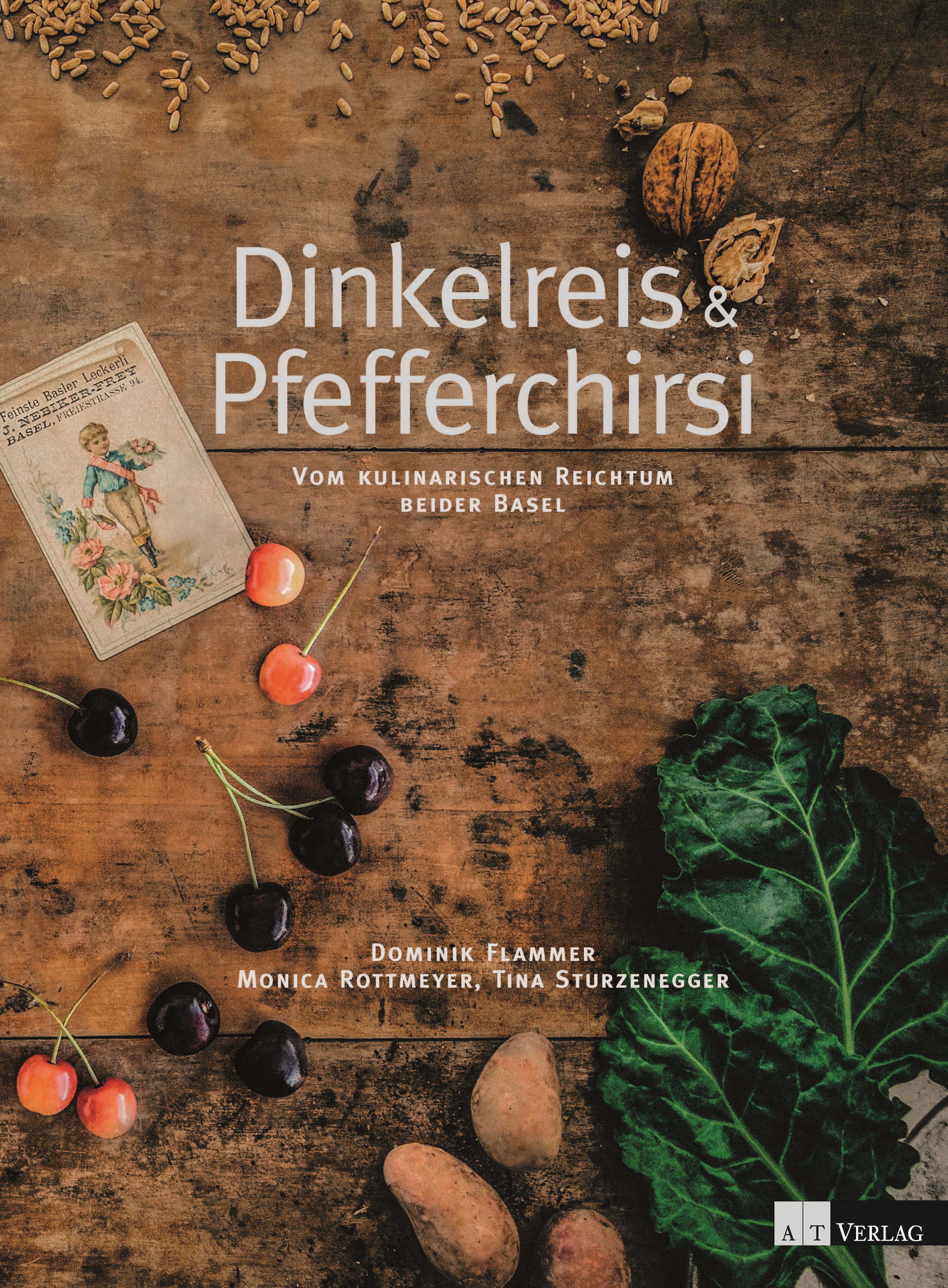 Buchcover mit Titel "Dinkelreis & Pfefferchirsi". Auf Holzuntergrund liegen Kirschen, Walnüsse, Blätter und Kartoffeln.