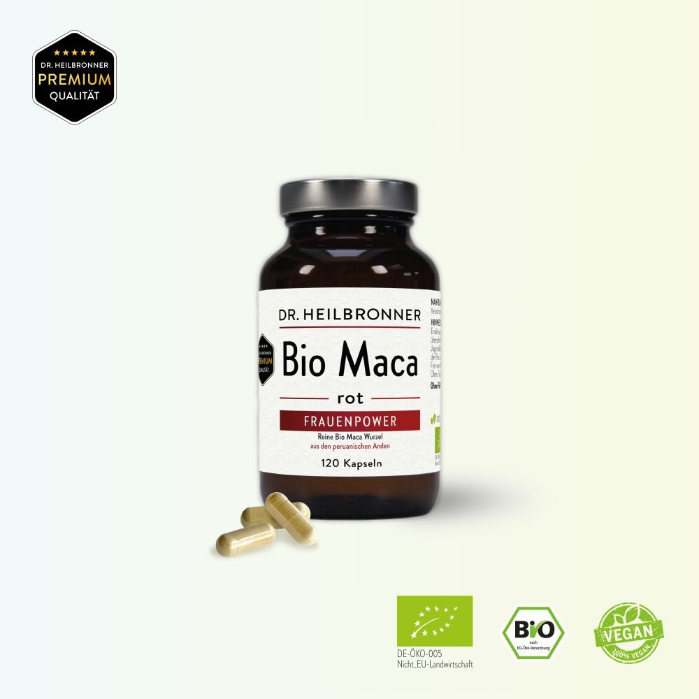 Braune Glasflasche mit silbernem Deckel. Etikett "Bio Maca rot". 3 Kapseln daneben. Bio- und Vegan-Siegel.