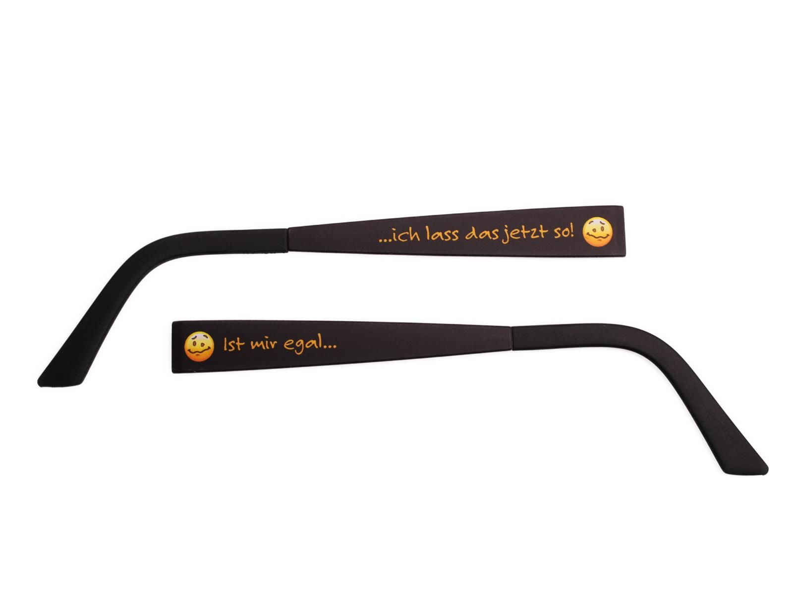 Zwei schwarze Wechselbügel mit Text und Smiley-Gesichtern. Auf einem steht: ...ich lass das jetzt so! Auf dem anderen: Ist mir egal...