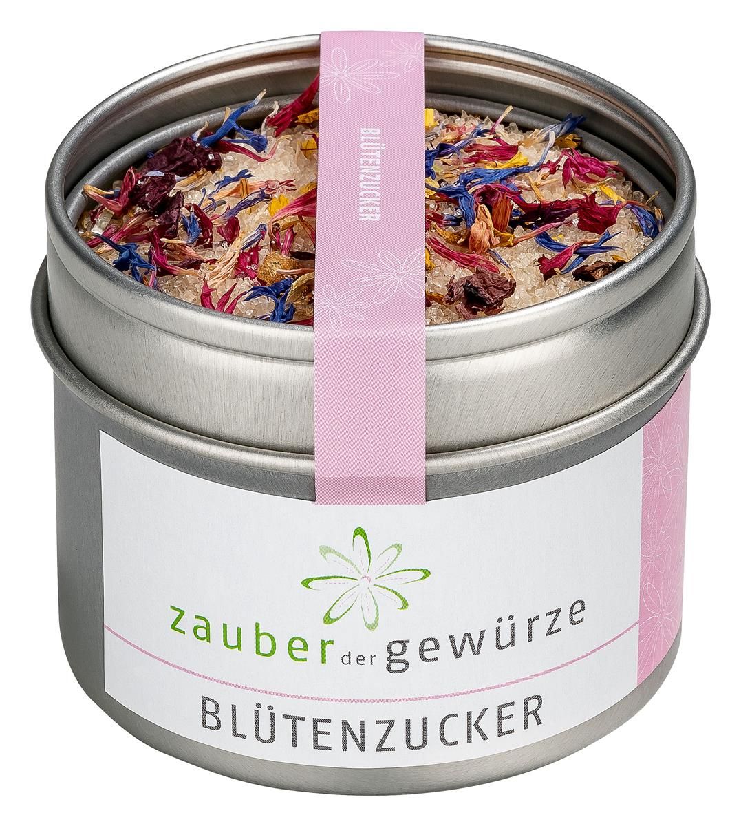 Runde Dose mit Blütenzucker. Rosa Etikett mit Schriftzug und Blütenmuster. Deckel offen, Inhalt sichtbar.