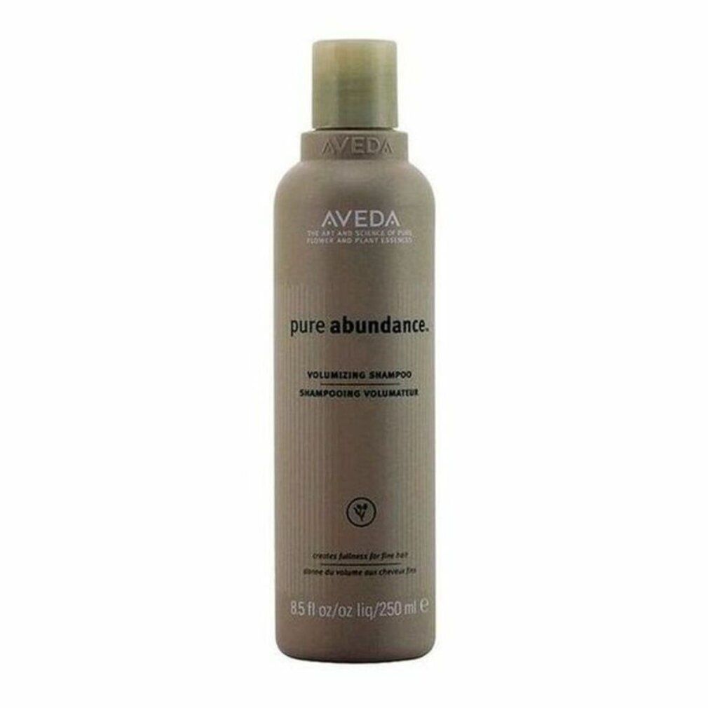 Kleine braune Flasche mit Aveda-Logo und Produktnamen. Text: Pure Abundance Volumizing Shampoo. Grüne Pflanzen-Illustration.