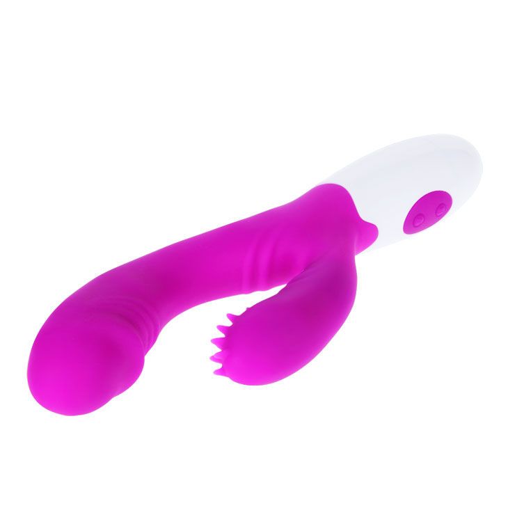 Lila Vibrator mit weißem Griff. Zwei Knöpfe am Griff. Gebogene Form mit strukturiertem Bereich. Auf weißem Hintergrund.